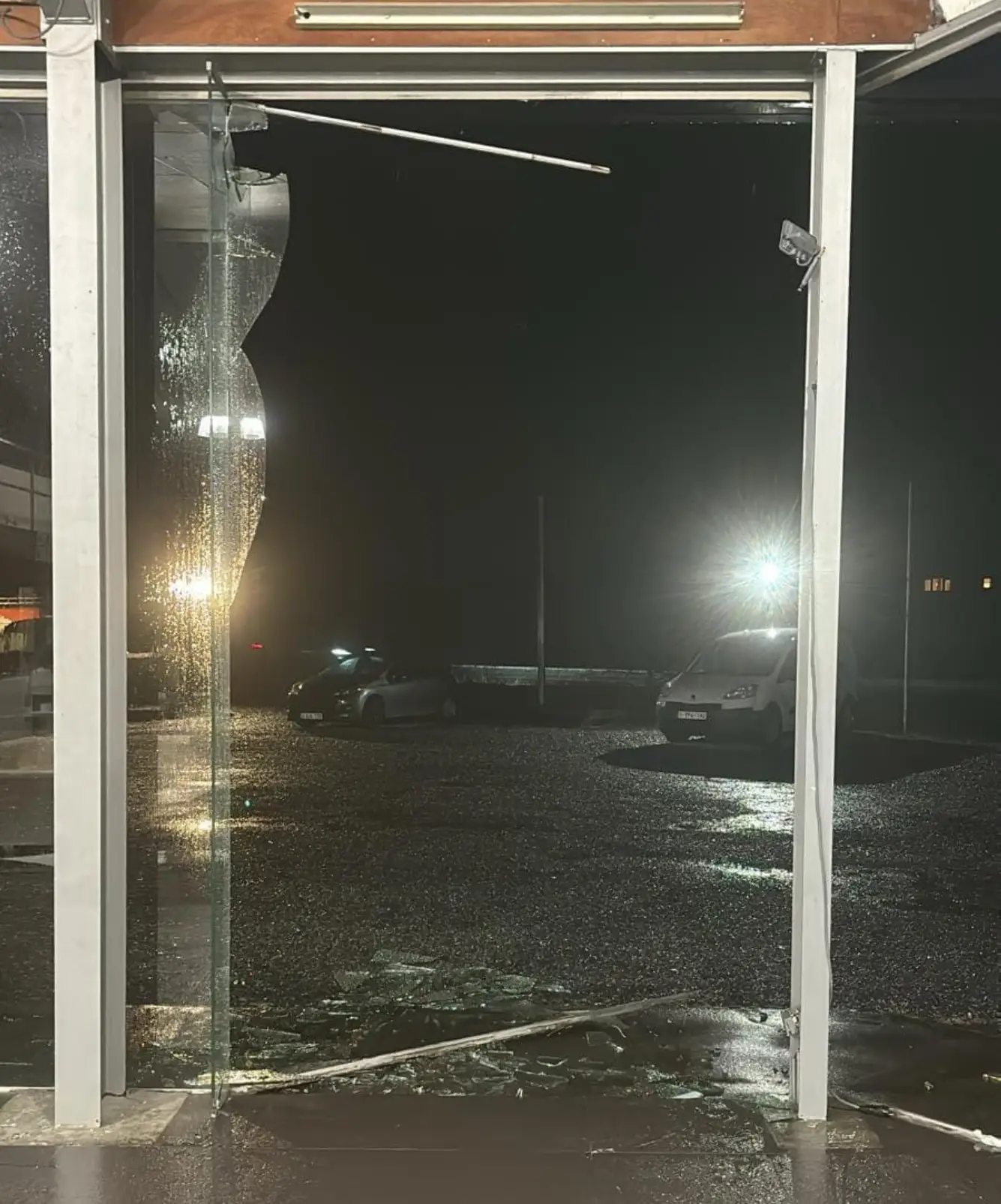 a broken glass window at night