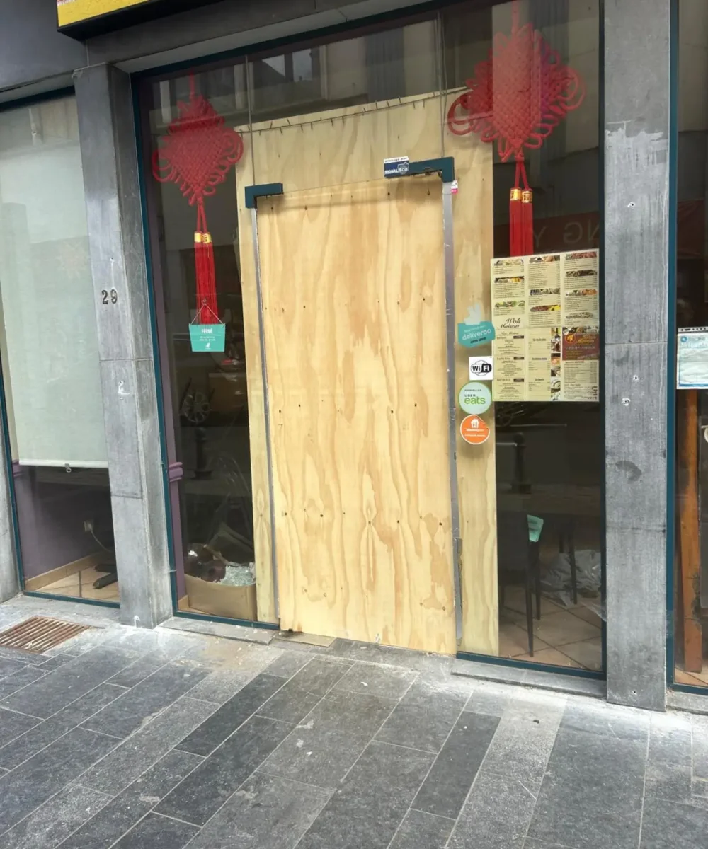 a wooden door with a sign on the front of a building