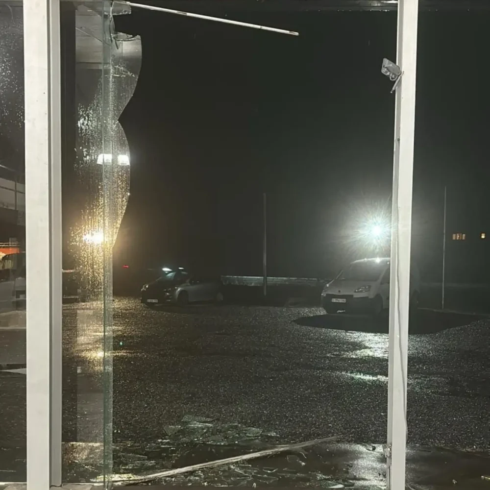 a broken glass window at night